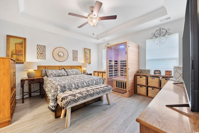 136 Queens Cove Pl Unit B, Myrtle Beach, SC 29579 - bedroom with a tray ceiling, ornamental molding, light wood-style flooring, and ceiling fan