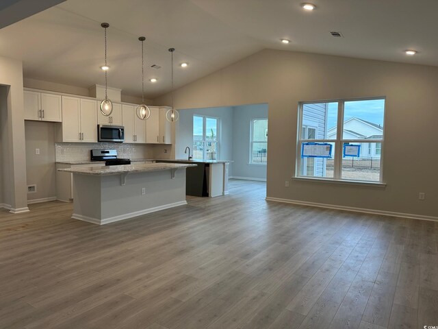 190 Glengrove Ln, Murrells Inlet, SC 29576 - kitchen with appliances with stainless steel finishes, a center island, white cabinets, healthy amount of natural light, and vaulted ceiling