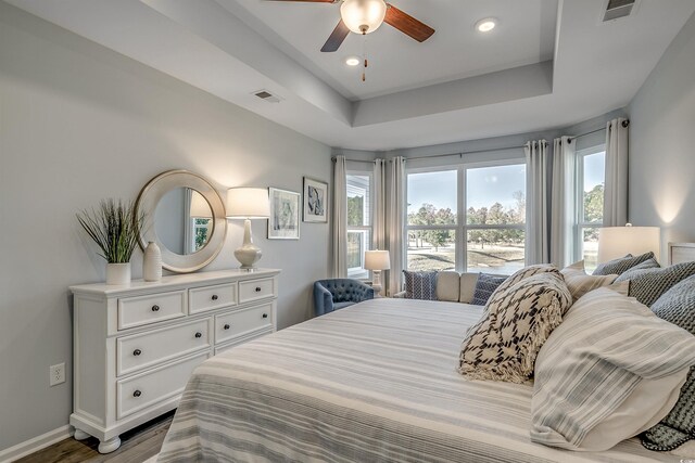 190 Glengrove Ln, Murrells Inlet, SC 29576 - bedroom with wood finished floors, a tray ceiling, a ceiling fan, and recessed lighting