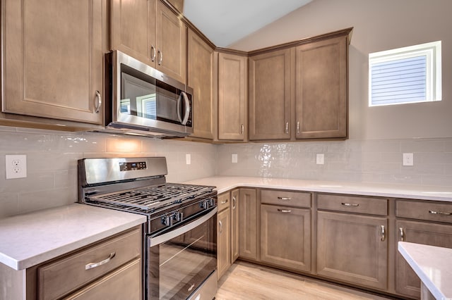 186 Glengrove Ln, Murrells Inlet, SC 29576 - kitchen featuring light countertops, decorative backsplash, appliances with stainless steel finishes, and lofted ceiling