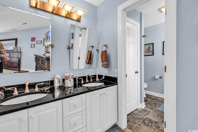 4755 Lightkeepers Way Unit 15-E, Little River, SC 29566 - bathroom featuring double vanity, toilet, baseboards, and a sink