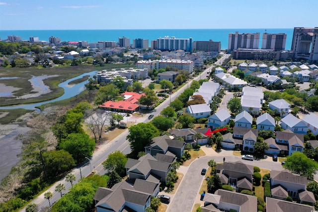 birds eye view of property featuring a water view and a city view