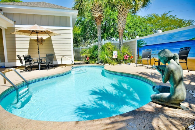 view of swimming pool featuring a patio, a fenced in pool, and a fenced backyard