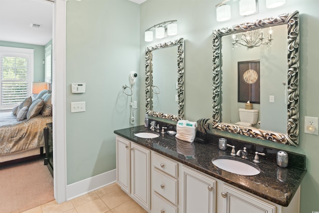 bathroom with tile patterned floors, visible vents, a sink, and ensuite bath