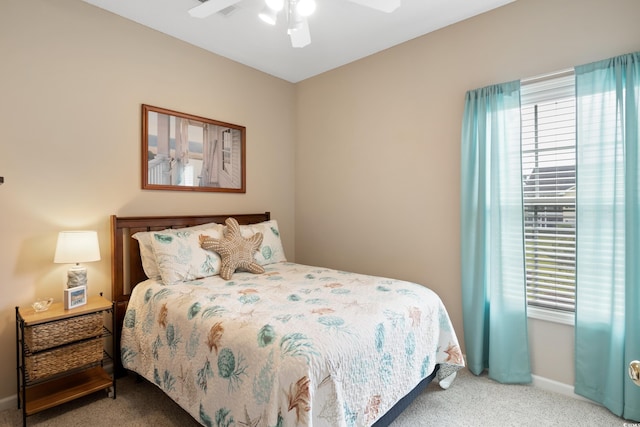 carpeted bedroom with baseboards and a ceiling fan