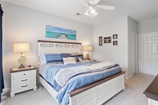 bedroom with light colored carpet, a ceiling fan, and baseboards