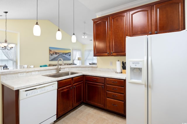 kitchen with white appliances, a sink, lofted ceiling, a peninsula, and decorative light fixtures