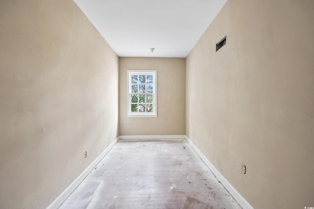 unfurnished room featuring baseboards