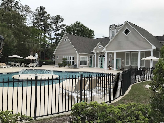 pool featuring a patio and fence