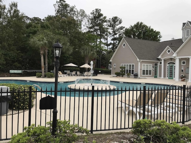 pool featuring a patio area and fence