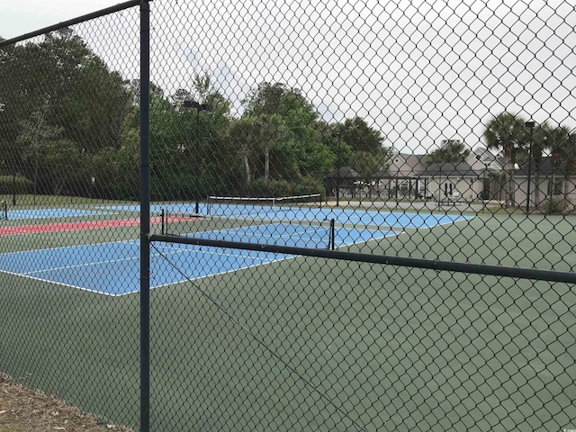 view of sport court featuring fence