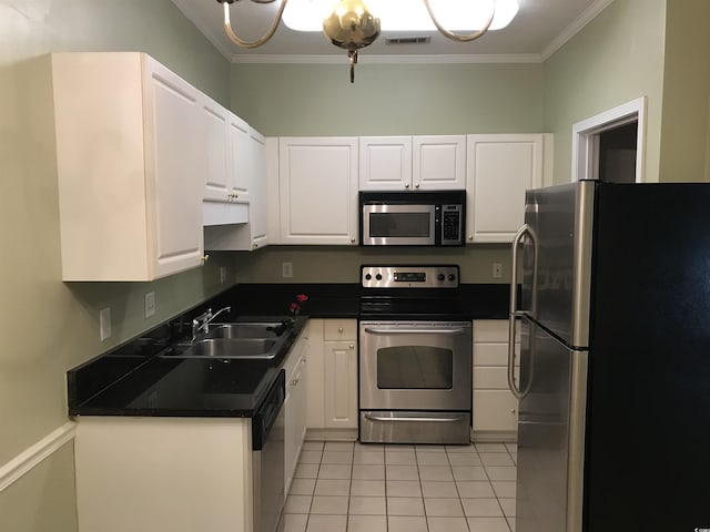 kitchen with ornamental molding, white cabinets, a sink, appliances with stainless steel finishes, and light tile patterned floors