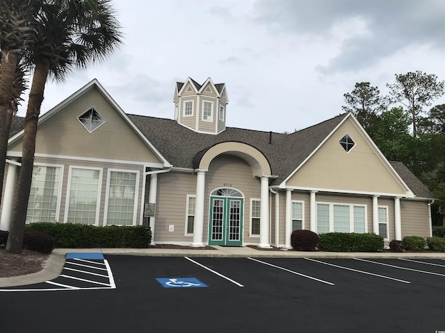 view of building exterior with uncovered parking