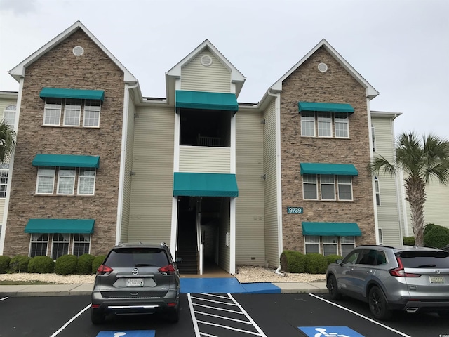 view of property featuring uncovered parking