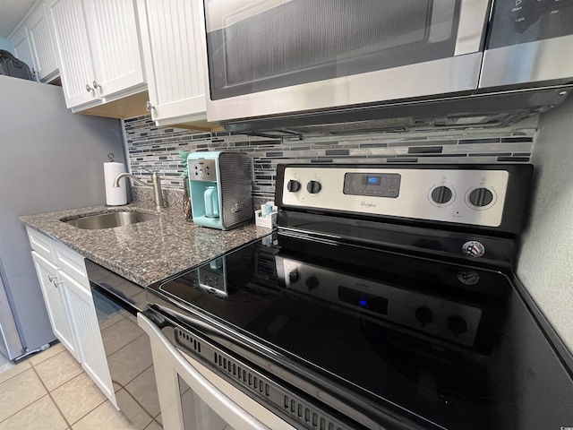 2701 S Ocean Blvd Unit 1507, North Myrtle Beach, SC 29582 - kitchen featuring appliances with stainless steel finishes, a sink, white cabinets, dark stone countertops, and decorative backsplash