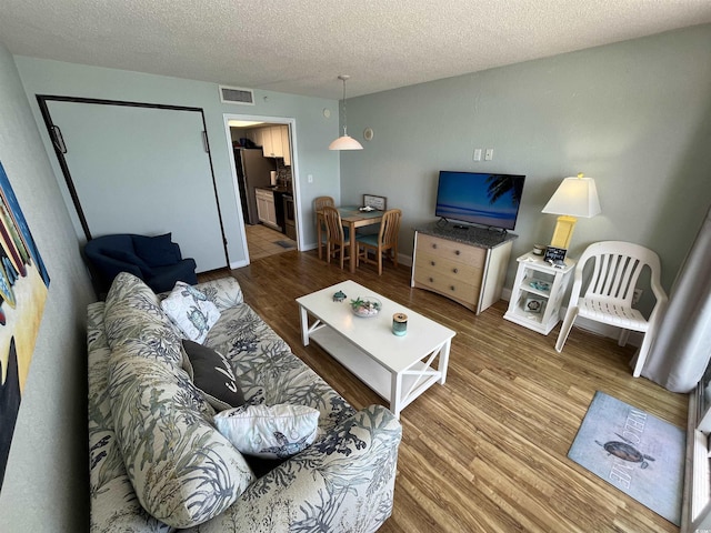 2701 S Ocean Blvd Unit 1507, North Myrtle Beach, SC 29582 - living area featuring wood finished floors and a textured ceiling