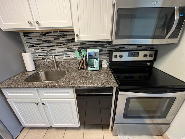 2701 S Ocean Blvd Unit 1507, North Myrtle Beach, SC 29582 - kitchen with appliances with stainless steel finishes, a sink, white cabinetry, and backsplash