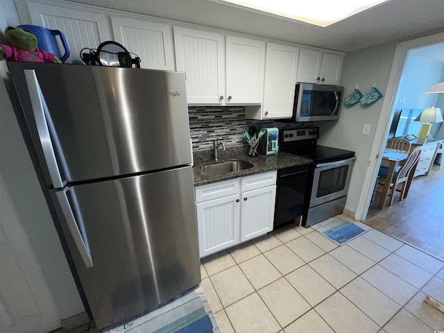 2701 S Ocean Blvd Unit 1507, North Myrtle Beach, SC 29582 - kitchen featuring appliances with stainless steel finishes, a sink, light tile patterned floors, and white cabinetry