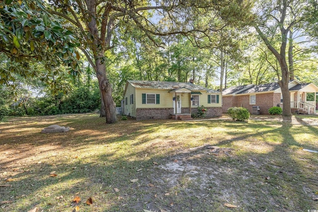 508 Pearl St, Conway, SC 29527 - view of front of home featuring a chimney, a front lawn, and brick siding
