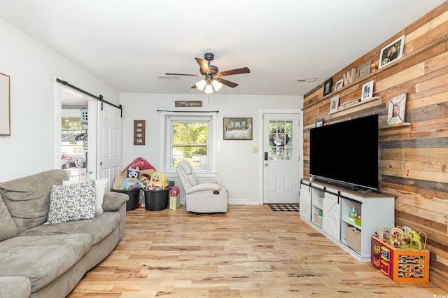 508 Pearl St, Conway, SC 29527 - living area featuring wooden walls, light wood-style floors, ceiling fan, and a barn door