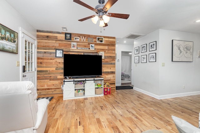 508 Pearl St, Conway, SC 29527 - living room featuring light wood-type flooring, a ceiling fan, visible vents, and wooden walls