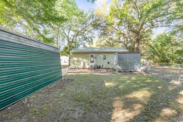 508 Pearl St, Conway, SC 29527 - rear view of house with fence, a patio area, and metal roof