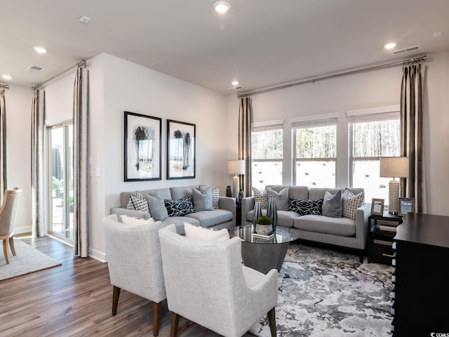 living area featuring recessed lighting, visible vents, and wood finished floors