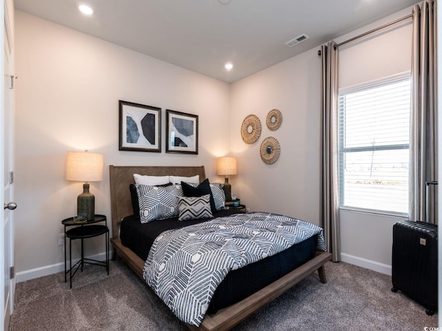 bedroom with baseboards, visible vents, multiple windows, and carpet