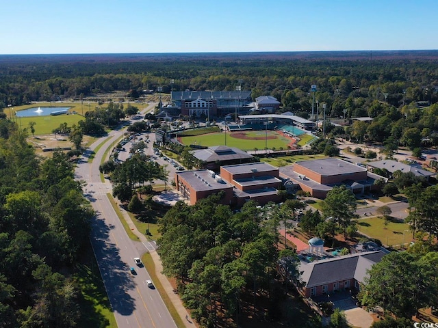drone / aerial view featuring a water view and a wooded view