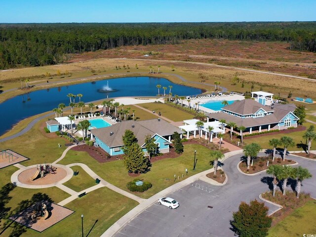 drone / aerial view with a water view and a forest view