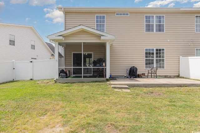 back of property featuring a sunroom, a fenced backyard, a patio, and a lawn