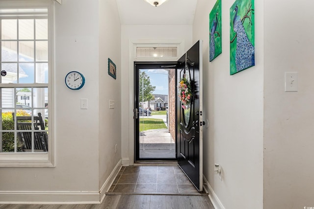 foyer entrance featuring baseboards and dark wood-style flooring