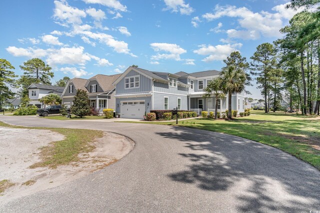 600 Waterbridge Blvd, Myrtle Beach, SC 29579 - shingle-style home with driveway, a front yard, board and batten siding, and a garage
