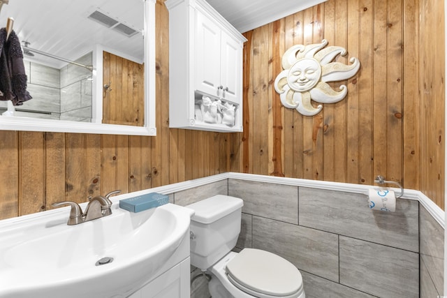 1012 N Waccamaw Dr Unit 507, Murrells Inlet, SC 29576 - bathroom featuring wooden walls, toilet, a shower, and vanity