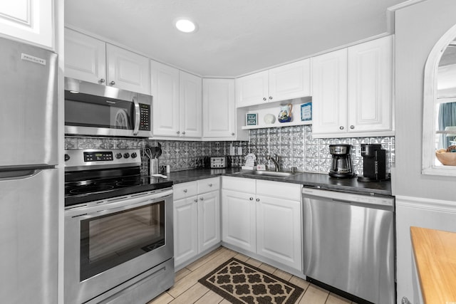 1012 N Waccamaw Dr Unit 507, Murrells Inlet, SC 29576 - kitchen featuring stainless steel appliances, a sink, white cabinetry, decorative backsplash, and recessed lighting