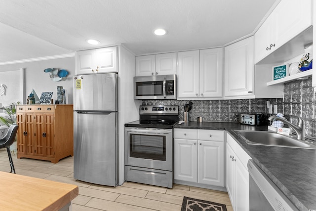1012 N Waccamaw Dr Unit 507, Murrells Inlet, SC 29576 - kitchen featuring stainless steel appliances, a sink, backsplash, white cabinetry, and ornamental molding