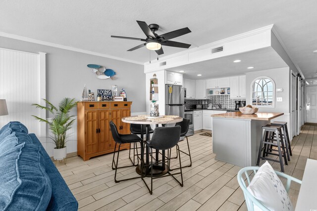 1012 N Waccamaw Dr Unit 507, Murrells Inlet, SC 29576 - dining room featuring light wood-type flooring, ceiling fan, ornamental molding, baseboards, and recessed lighting