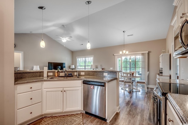 kitchen with appliances with stainless steel finishes, a sink, light wood finished floors, and ceiling fan with notable chandelier