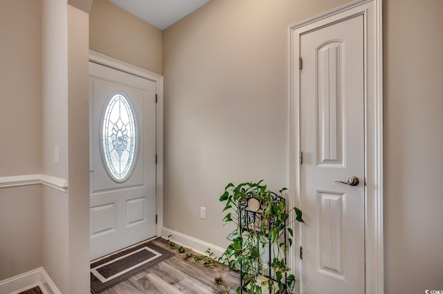 entrance foyer featuring wood finished floors and baseboards