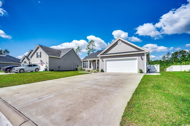 ranch-style house featuring a gate, concrete driveway, fence, an attached garage, and a front yard