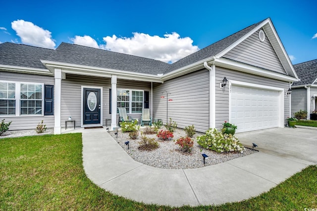 single story home featuring a garage, driveway, covered porch, a front yard, and roof with shingles