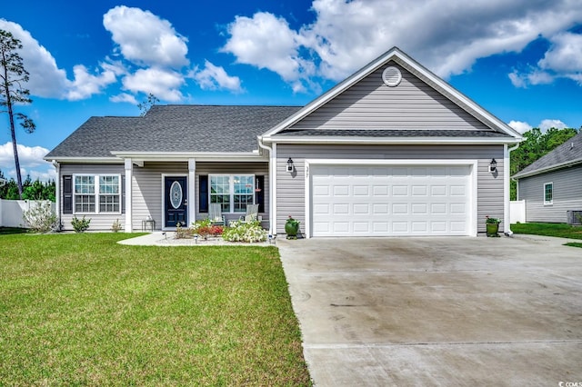 view of front of home featuring central AC unit, driveway, fence, an attached garage, and a front yard
