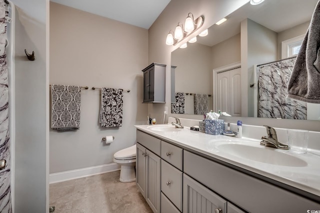 full bathroom featuring baseboards, a sink, double vanity, and toilet