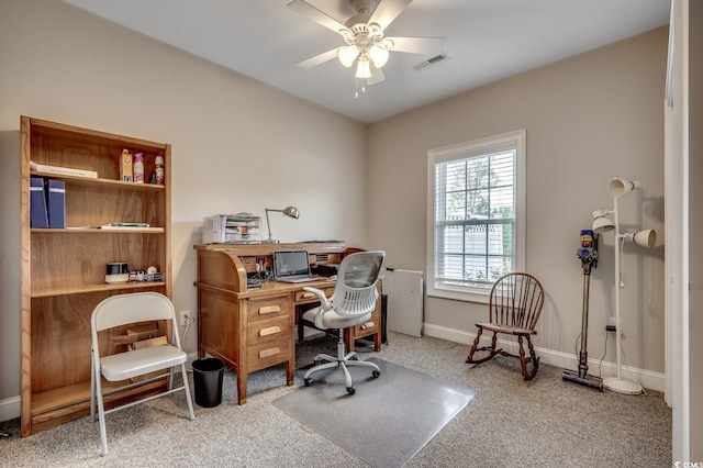 carpeted office with ceiling fan, baseboards, and visible vents