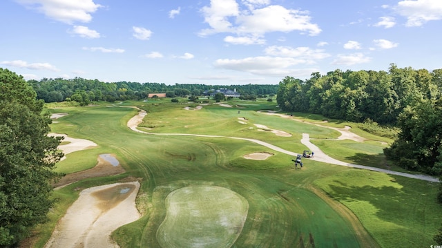 aerial overview of property's location with a tree filled landscape and a golf course