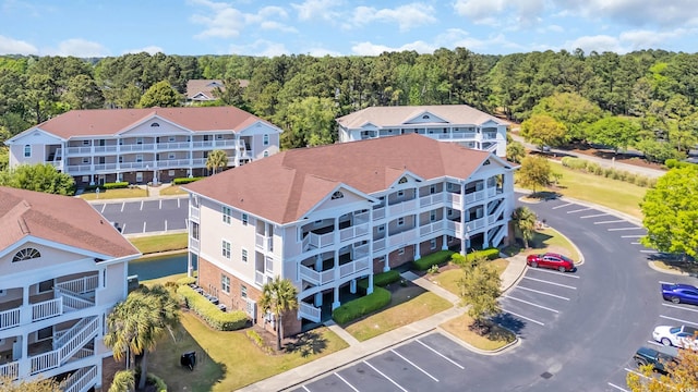 bird's eye view of a forest and apartment complex / building