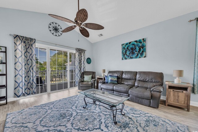 living room featuring a ceiling fan, wood finished floors, baseboards, and high vaulted ceiling
