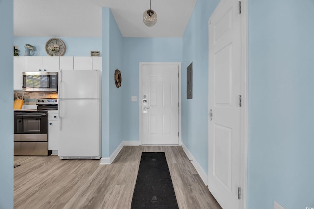 entrance foyer with light wood-type flooring, baseboards, and electric panel
