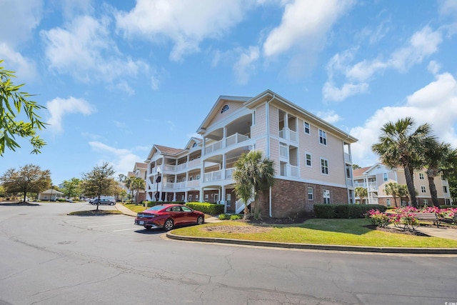 view of building exterior featuring uncovered parking
