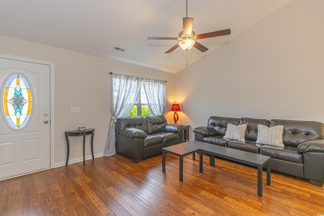 living room with visible vents, baseboards, vaulted ceiling, wood finished floors, and a ceiling fan
